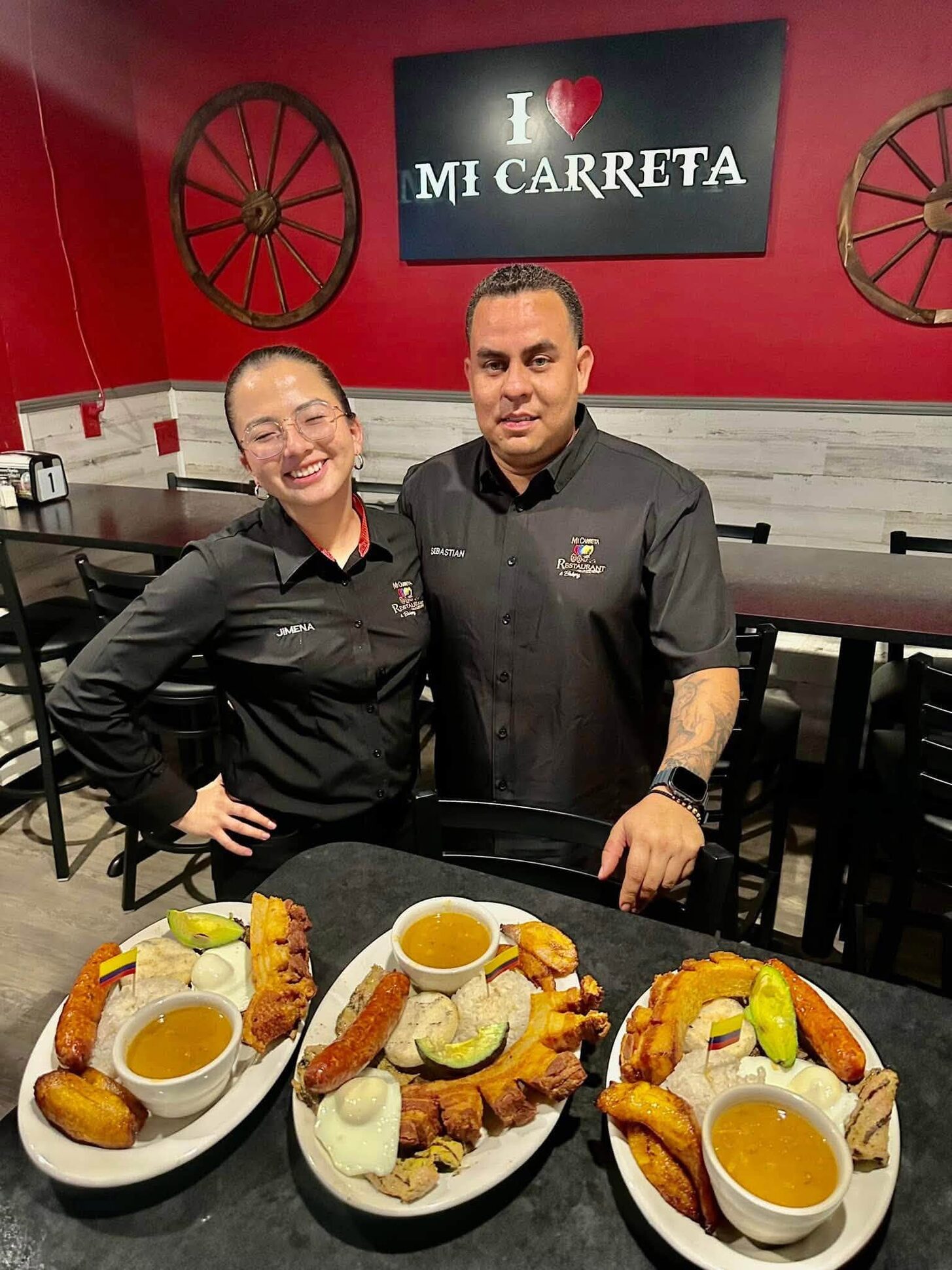 Two Mi Carreta team members behind three plated breakfasts