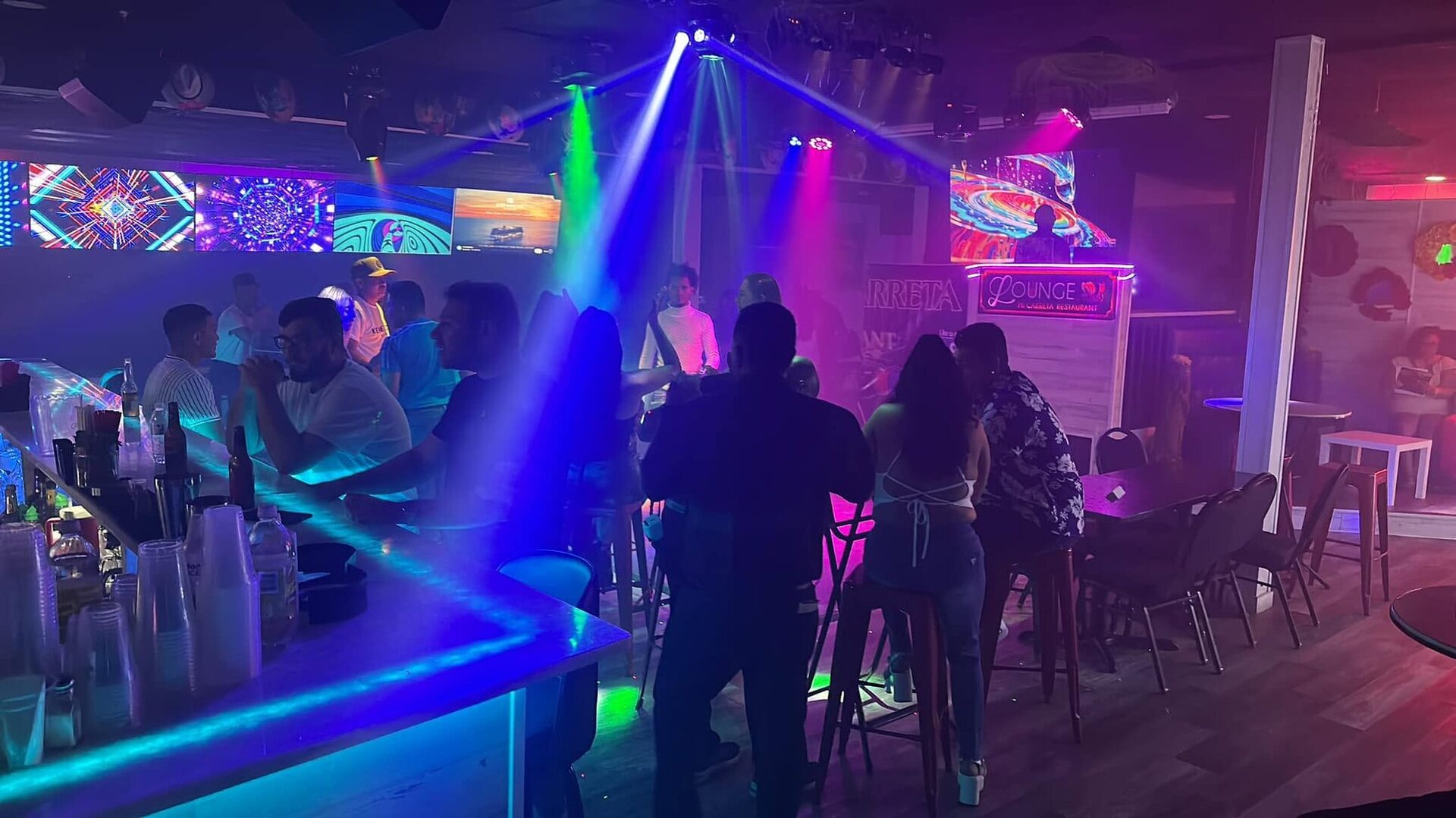 The Lounge on a weekend night: colored lights over a crowded bar