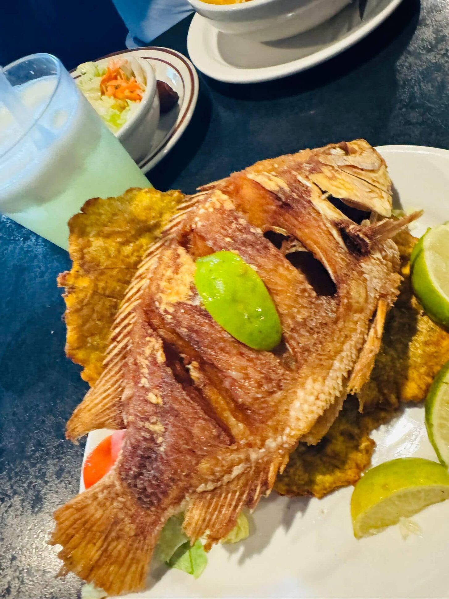 Whole fried red snapper with lime and patacones