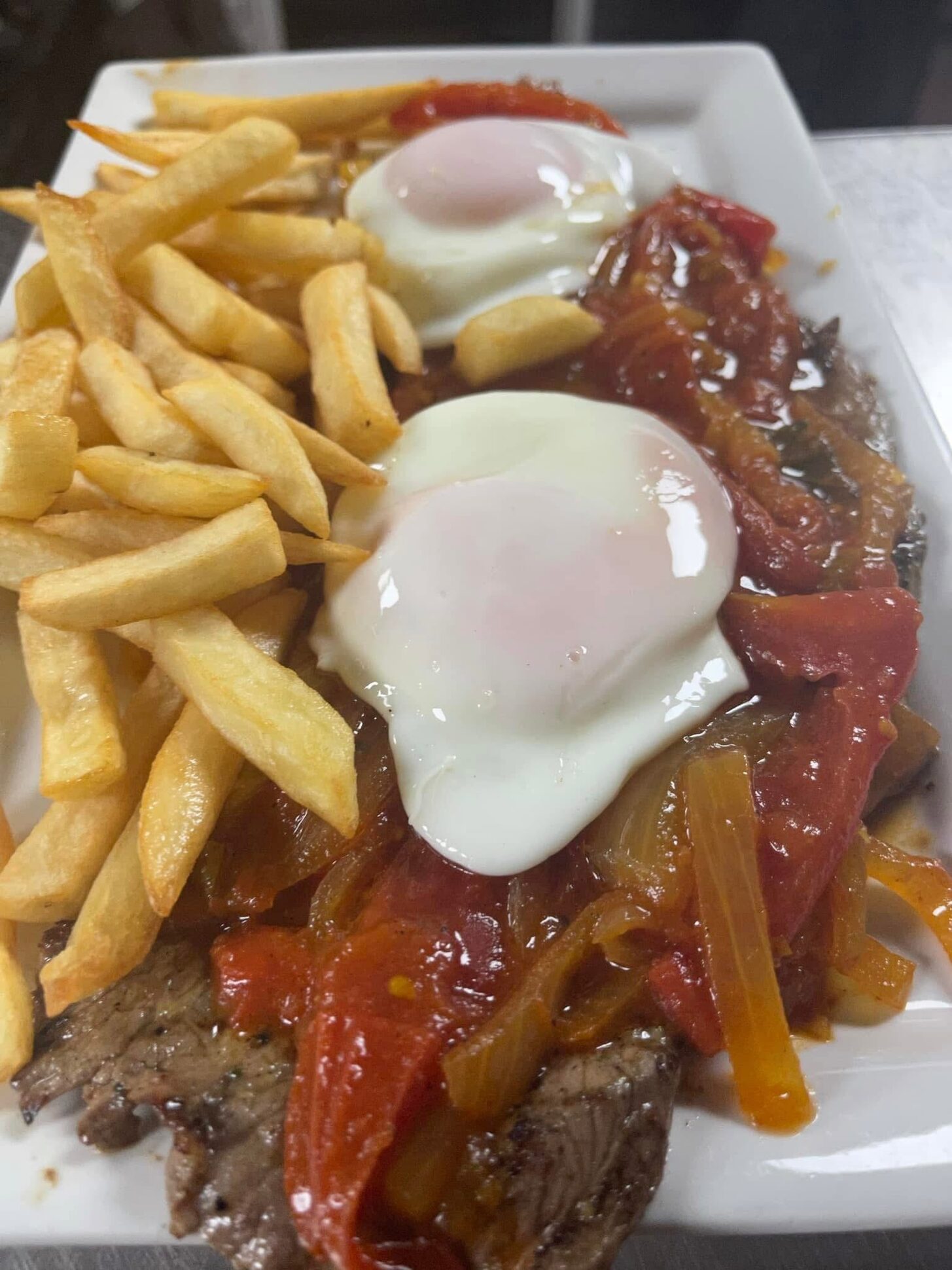 Bistec a caballo with fried eggs and French fries