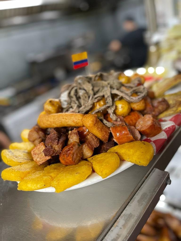 A heaping picada of chicharrón, chorizo, papa criolla and plantains