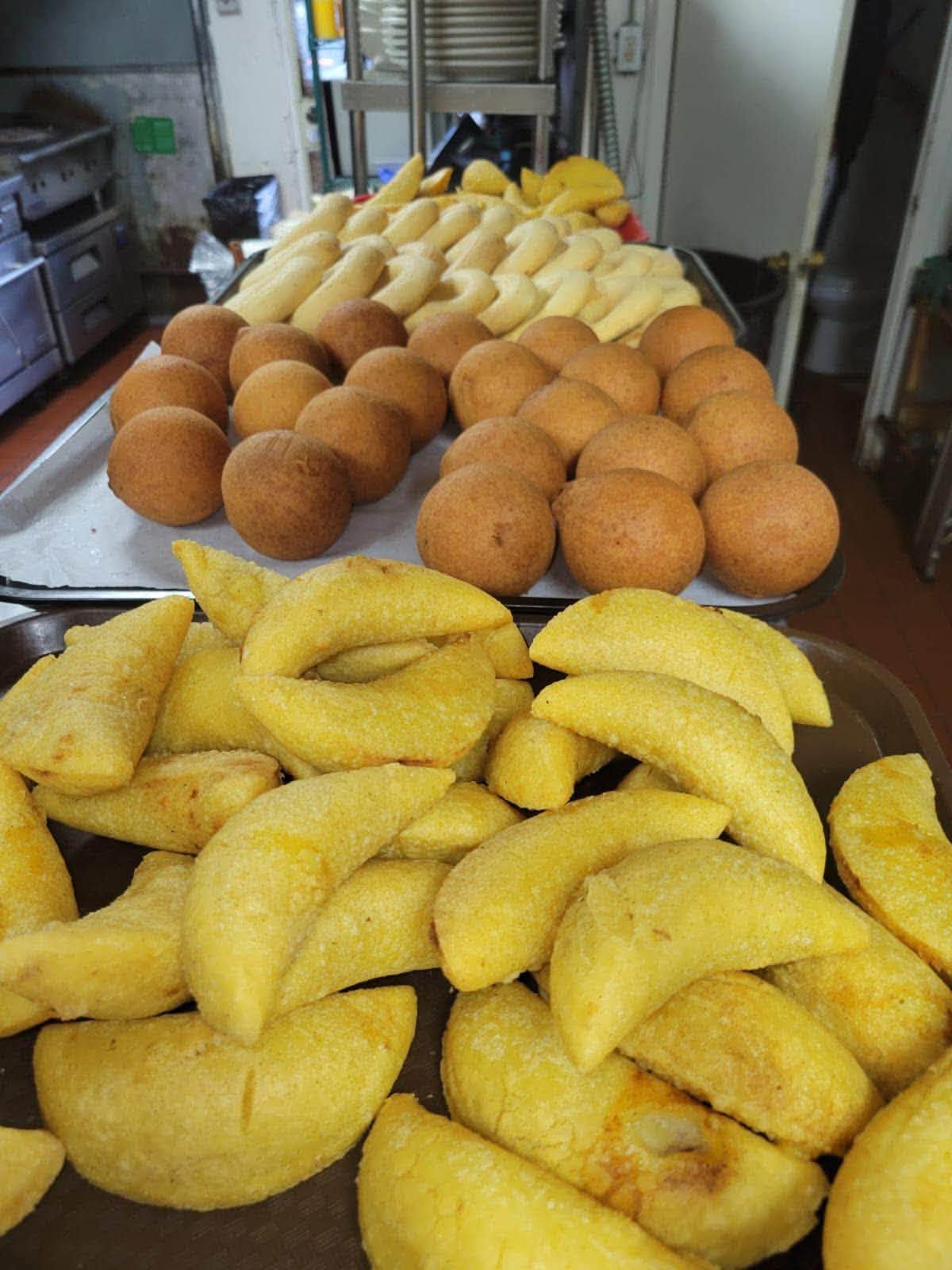 Trays of empanadas and buñuelos in the kitchen