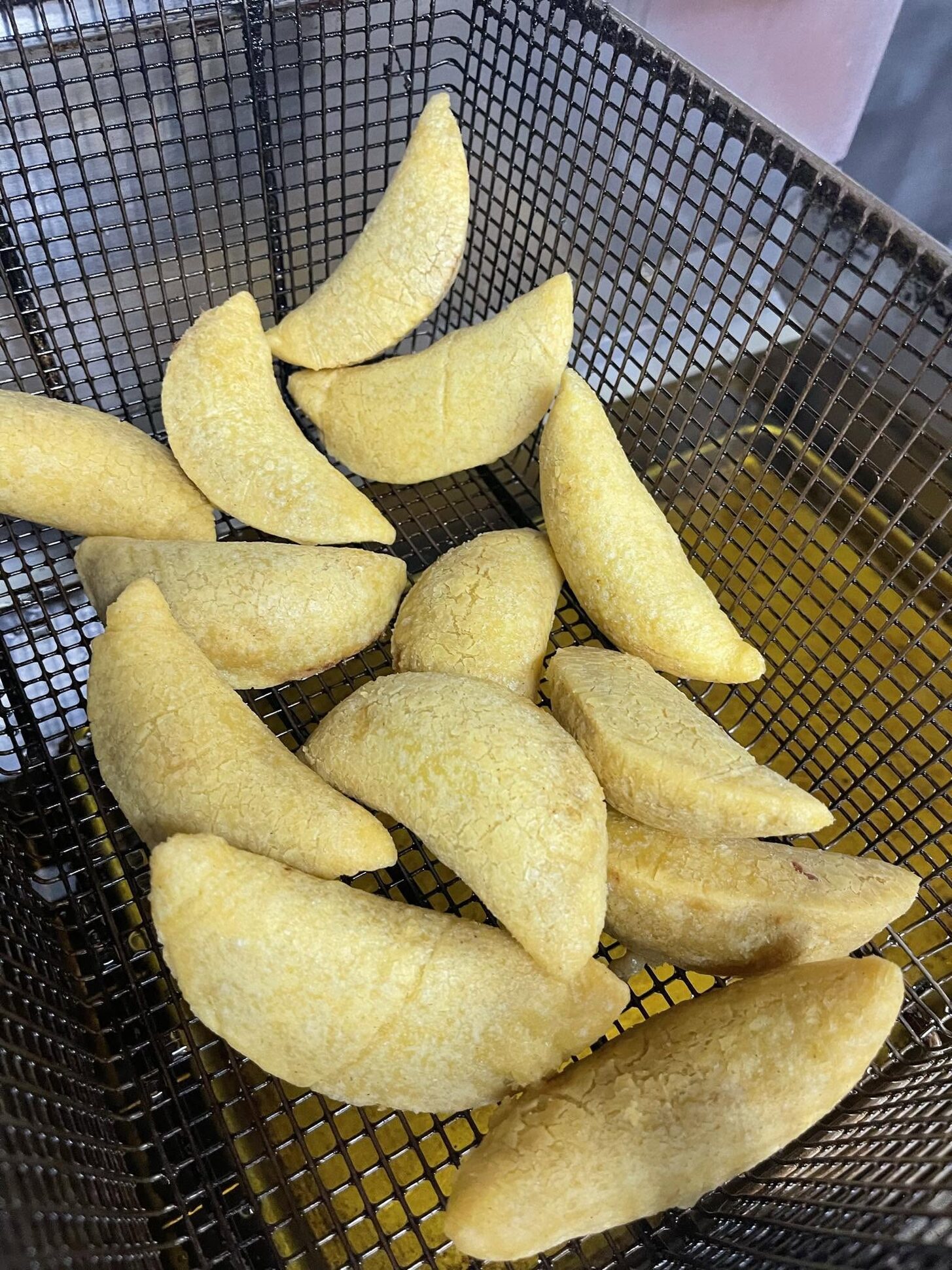 Empanadas in a fryer basket