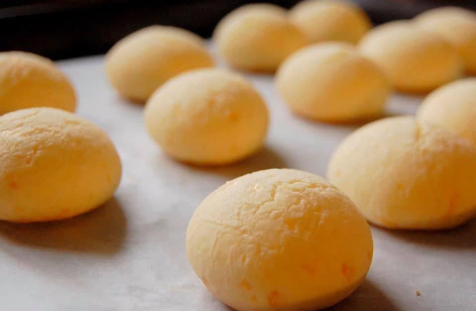 Soft pandebono rolls on parchment