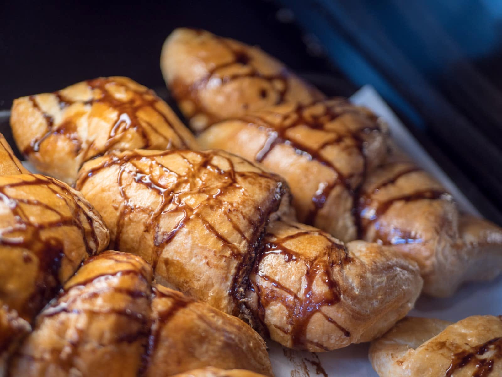 Glazed pastries drizzled with chocolate
