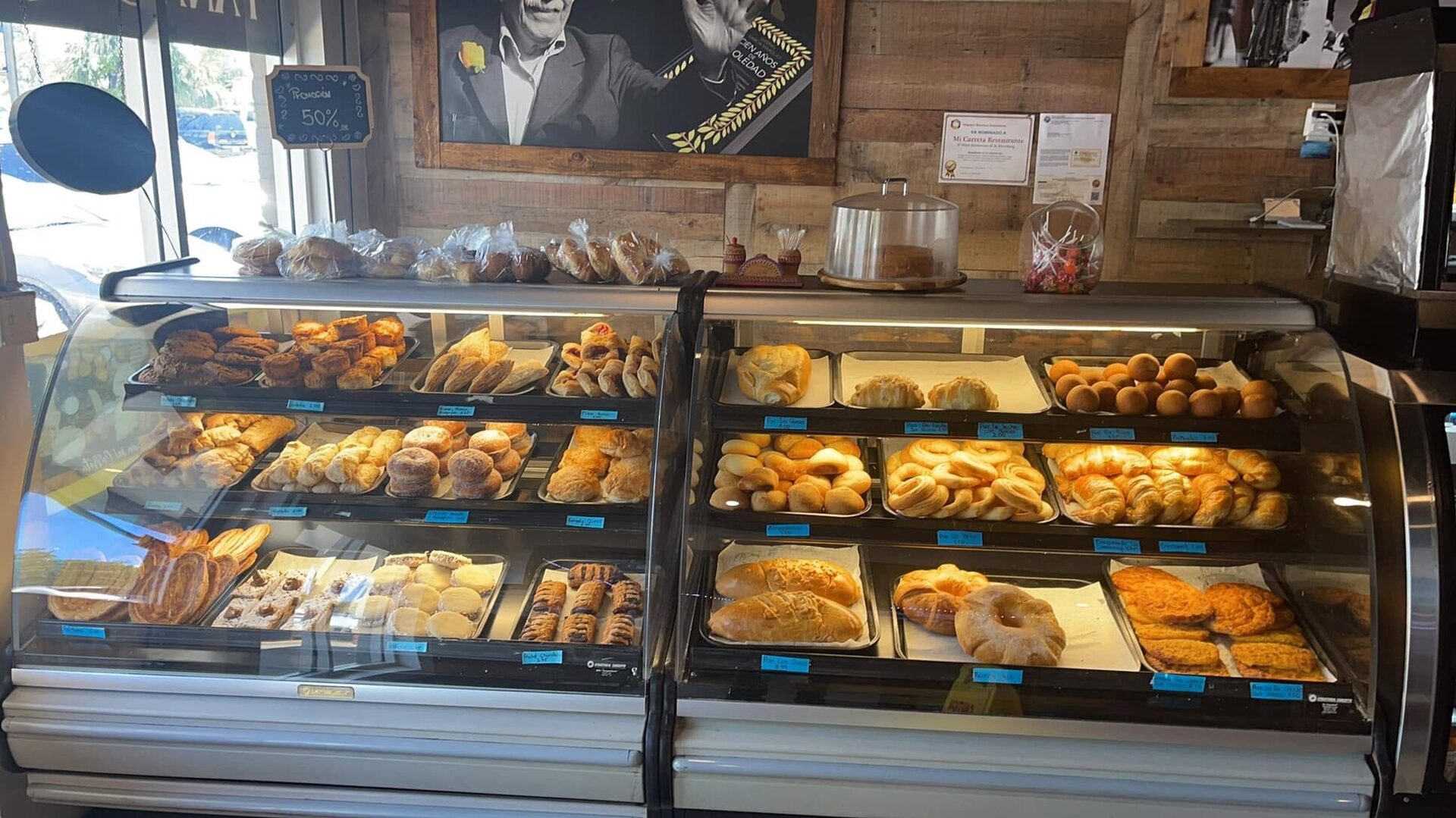 The Mi Carreta glass bakery case, full of breads and pastries