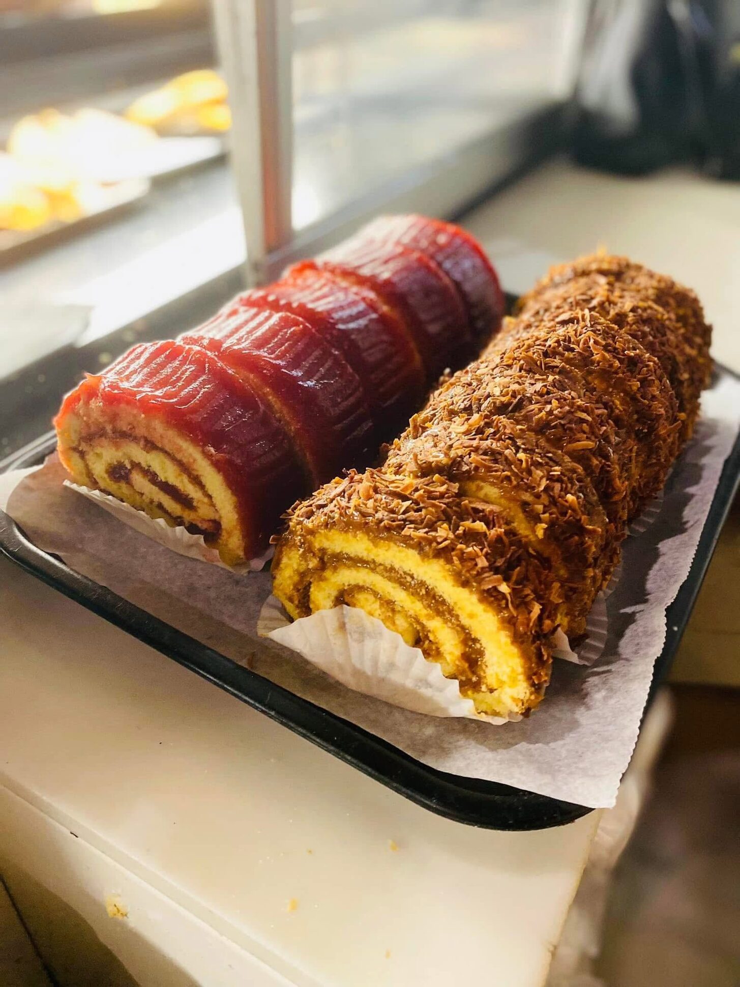 Guava and arequipe roll cakes in the bakery case