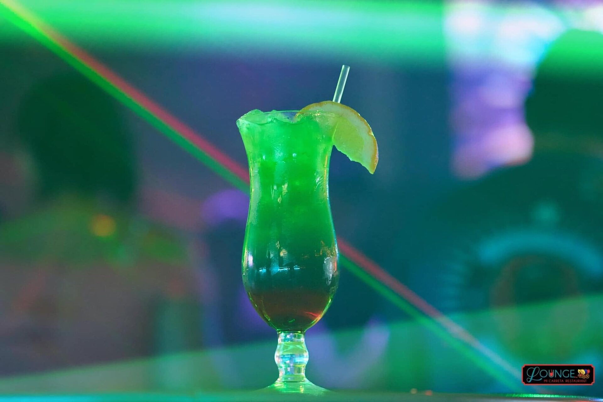 A green cocktail under club light